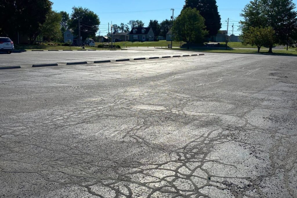 Parking lot with asphalt cracks that need to be repaired